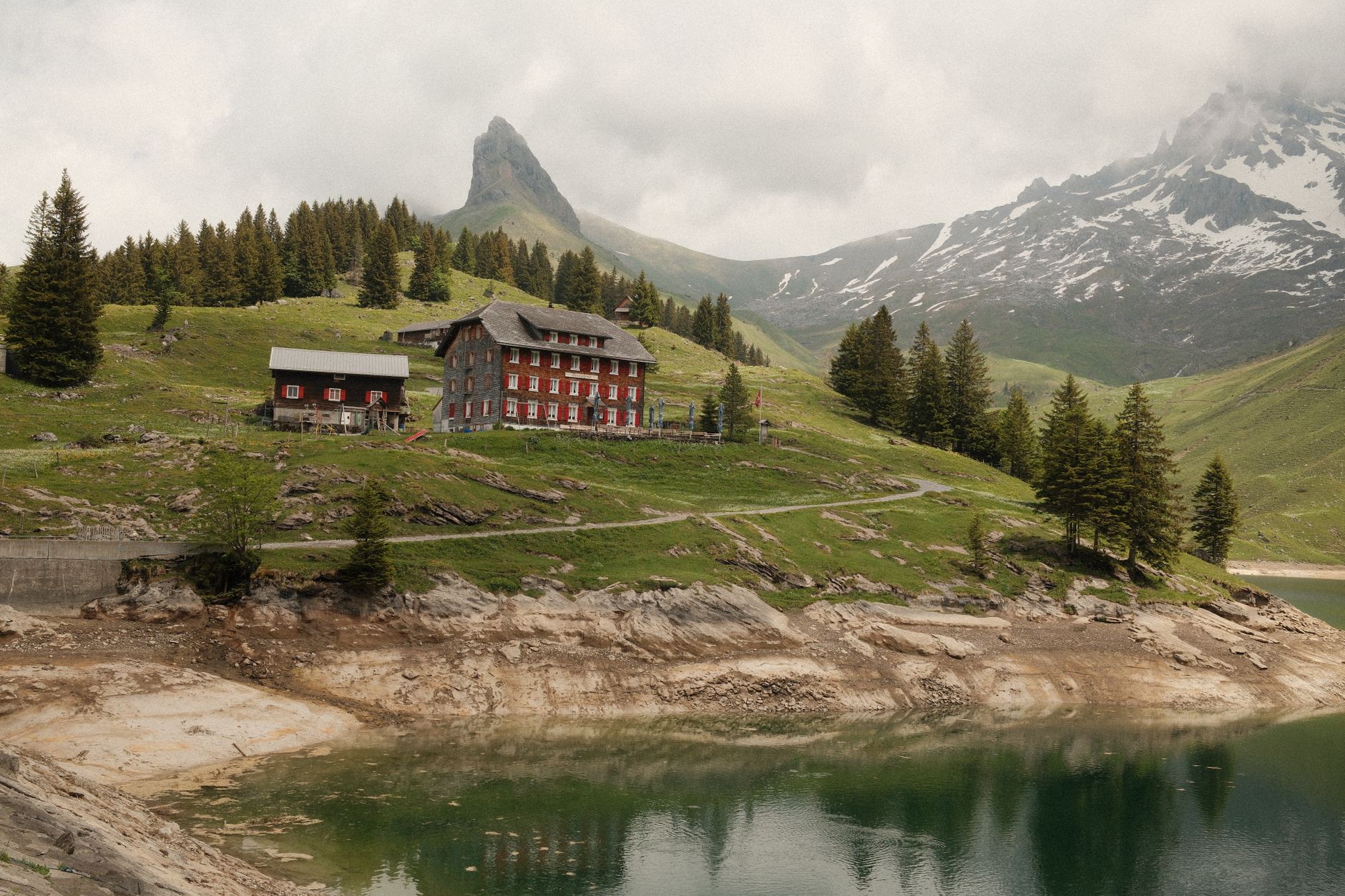 Picturesque view of alpine landscape with rustic chalet and mountains in Switzerland. — photograph by Ilia Bronskiy on Pexels