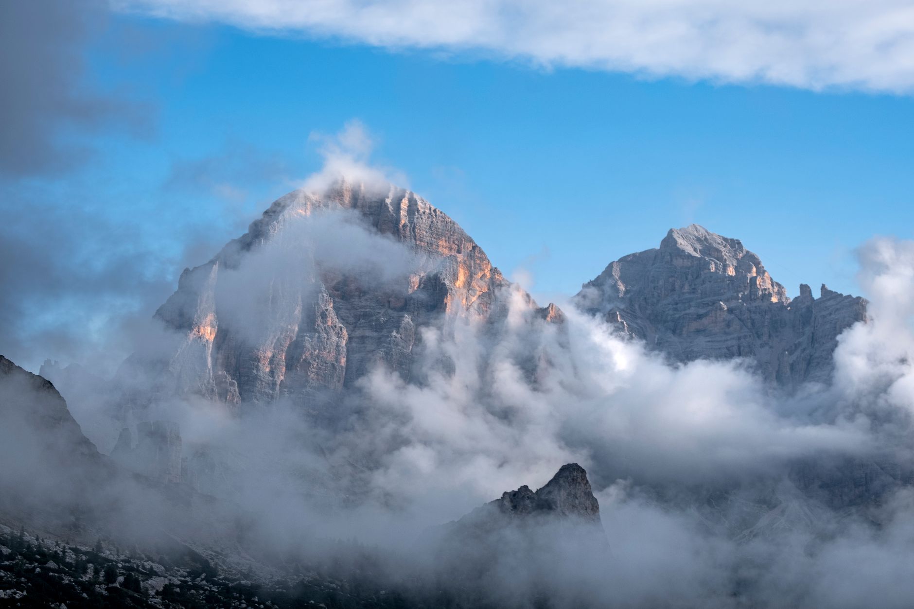 Breathtaking view of the Tofane peaks shrouded in clouds in the Dolomites, Cortina d'Ampezzo, Italy. — photograph by Francesco Fanti on Pexels
