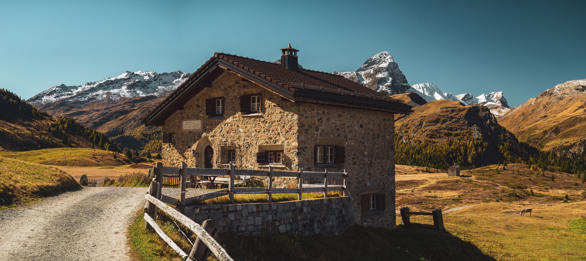 Charming stone chalet set against the picturesque backdrop of the Swiss Alps in autumn. — photograph by Christopher Politano on Pexels