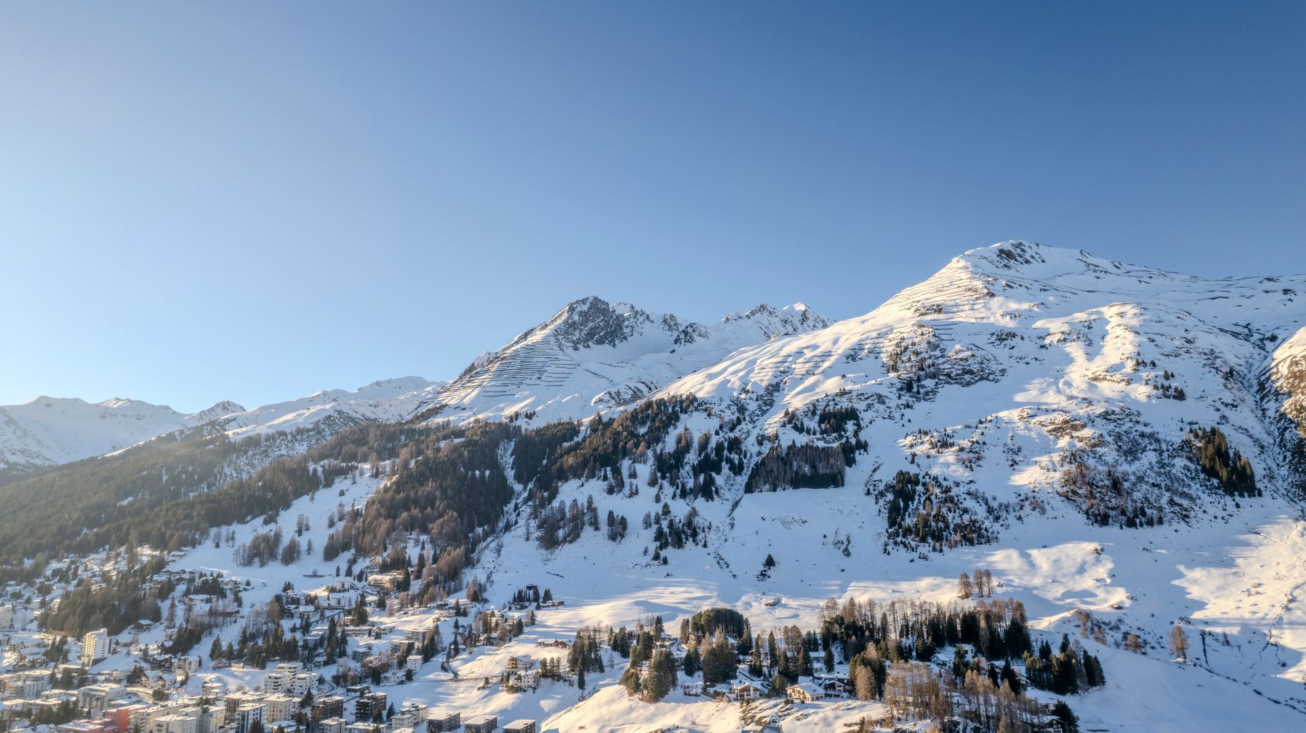 Breathtaking view of snow-covered mountains in Davos, Switzerland during winter. — photograph by Ollie Craig on Pexels